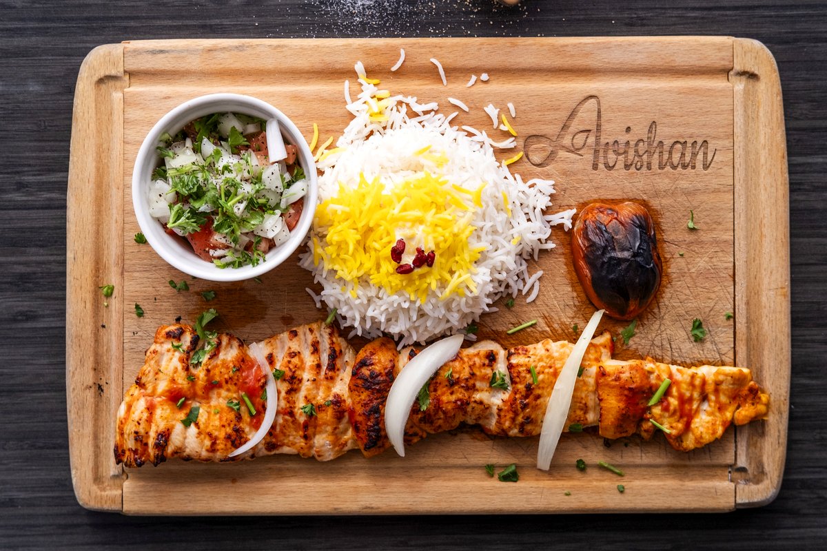 Chicken kebab with saffron rice and grilled tomato