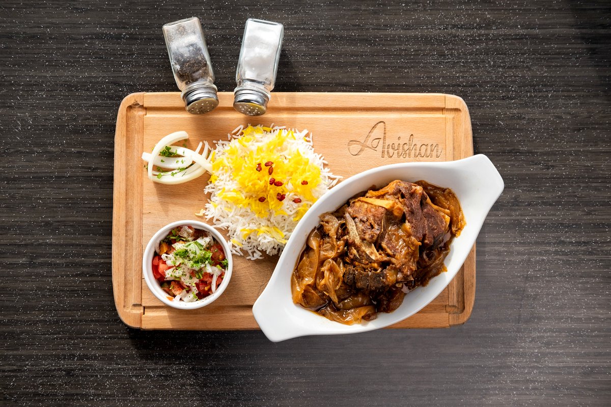 Slow roasted lamb neck with saffron rice and salad