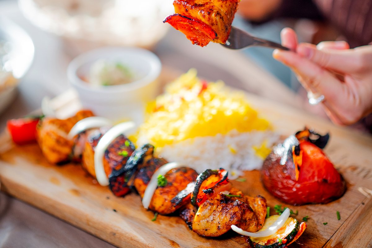 Grilled salmon kebab with saffron rice and grilled vegetables