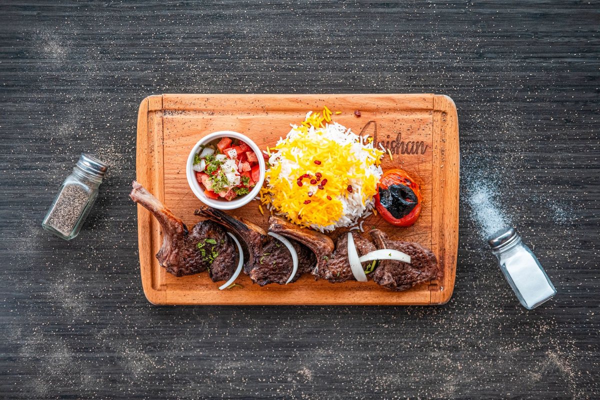 Shishlik rack of lamb with saffron rice, grilled tomato and salad