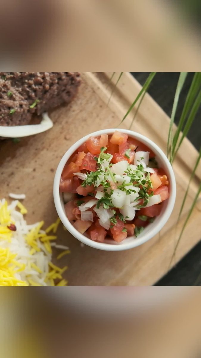 Kashk bademjan eggplant dip plated with herbs